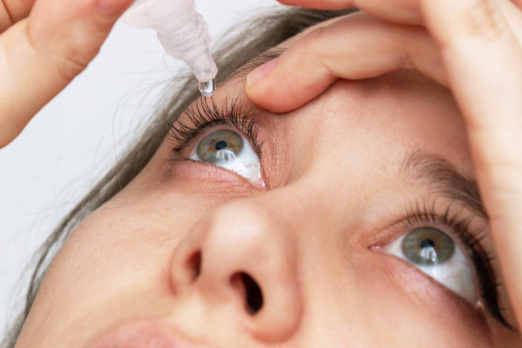 Patient using eye drops